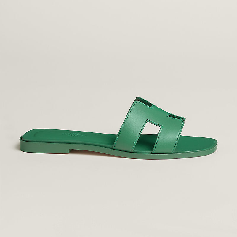 Green sandal on a light gray background