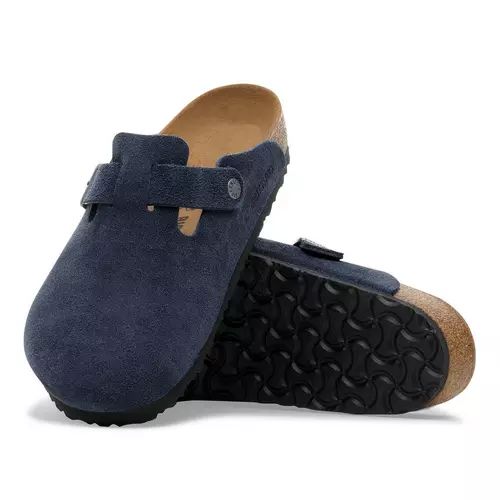Pair of navy blue clogs with cork soles on a white background