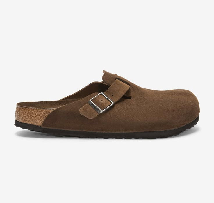 Brown clog shoe with a buckle on a white background