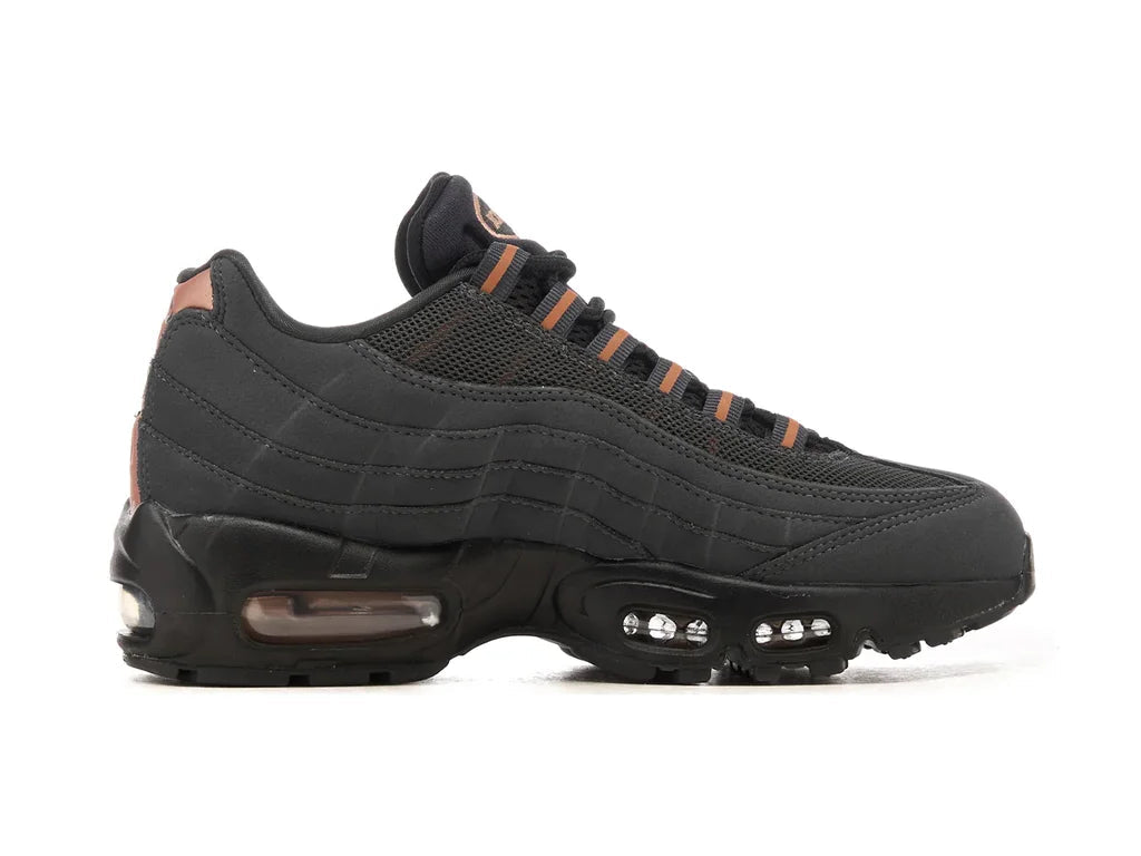 Green hiking boot with black sole on a white background
