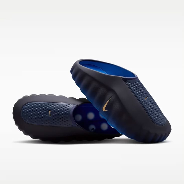 Pair of navy blue sandals with a white background