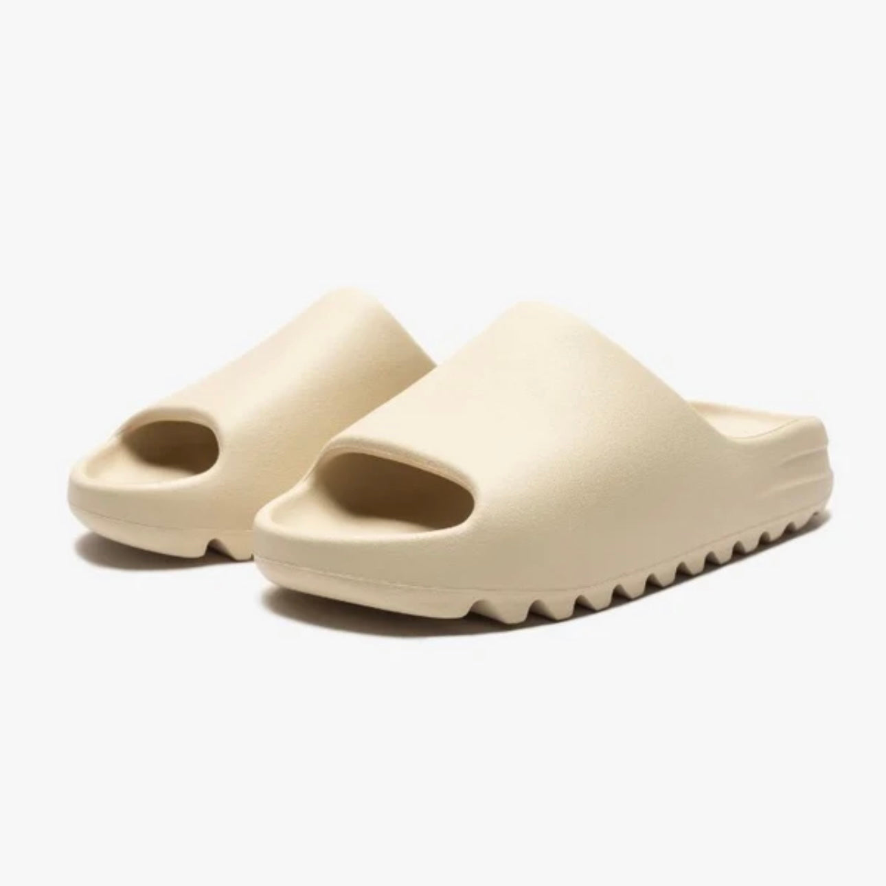 Pair of beige slides on a white background