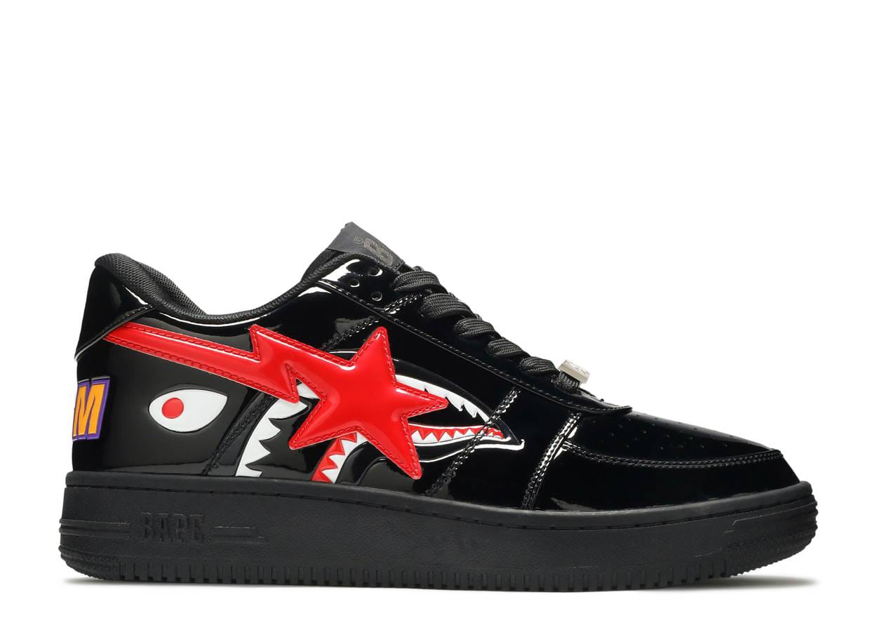 Black sneaker with red star and shark mouth design on a white background