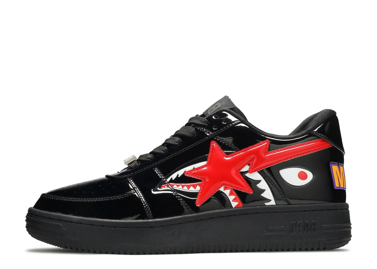 Black sneaker with red star and shark mouth design on a white background