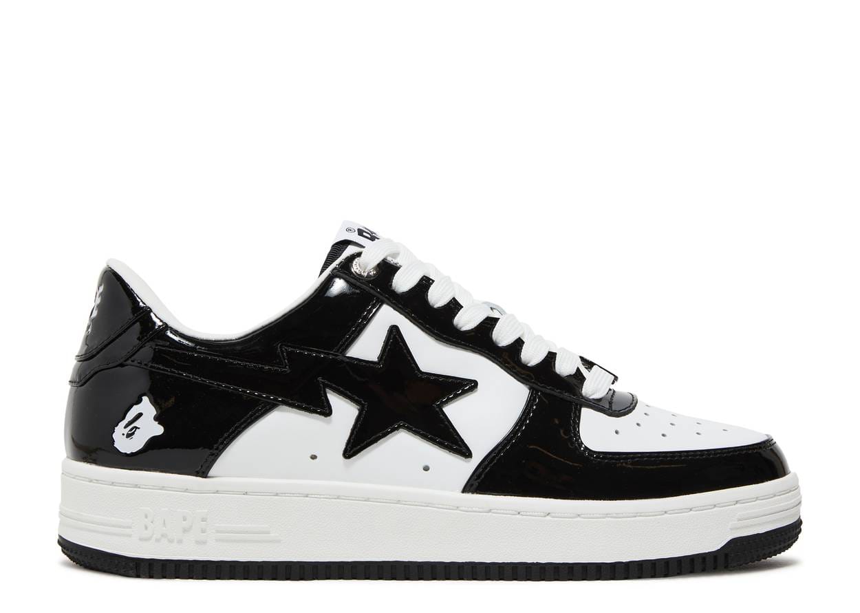 A low-top sneaker featuring a glossy black and white color-blocked design with a large black star on the side, white laces, and a white midsole with black branding.