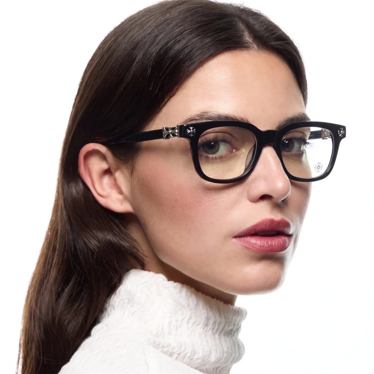 A close-up portrait of a woman wearing black square eyeglasses with decorative silver-tone star details on the temples, set against a plain white background.